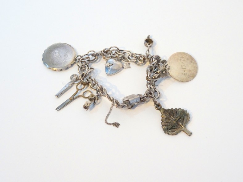 Lee Franclemont's charm bracelet, which charms from 1940s and beyond. Photo credit Kelise Franclemont.
